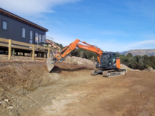 Hitachi excavator working on cut and fill next to new build on Blenheim hilltop