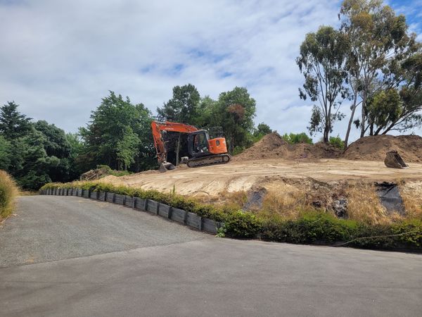 Earthmoving in progress on steep hillside cut and fill site