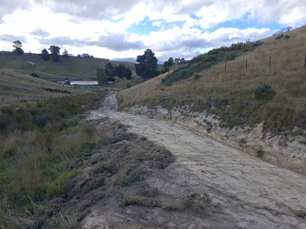 Rural track at Delta Lakes Marlborough after re-cutting the water table, with shaped cross-fall and silt trap visible above a small farm dam