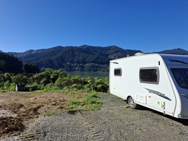 Owners' caravan in place on the levelled gravel area overlooking Mahau Sound