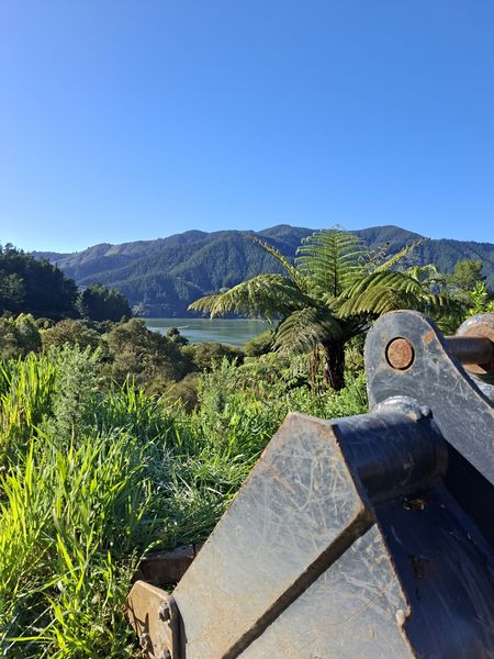DirtPro excavator bucket at the top of the section, looking out over Mahau Sound