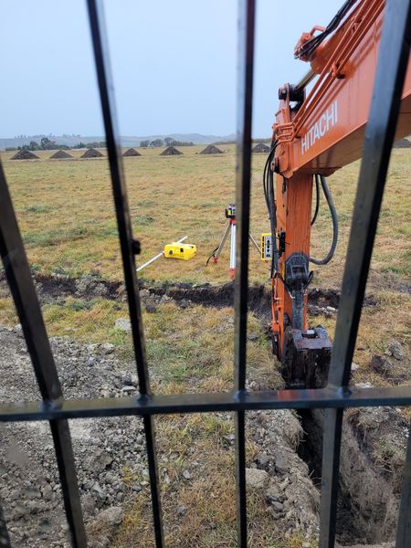 Hitachi excavator with laser level for precise drainage installation